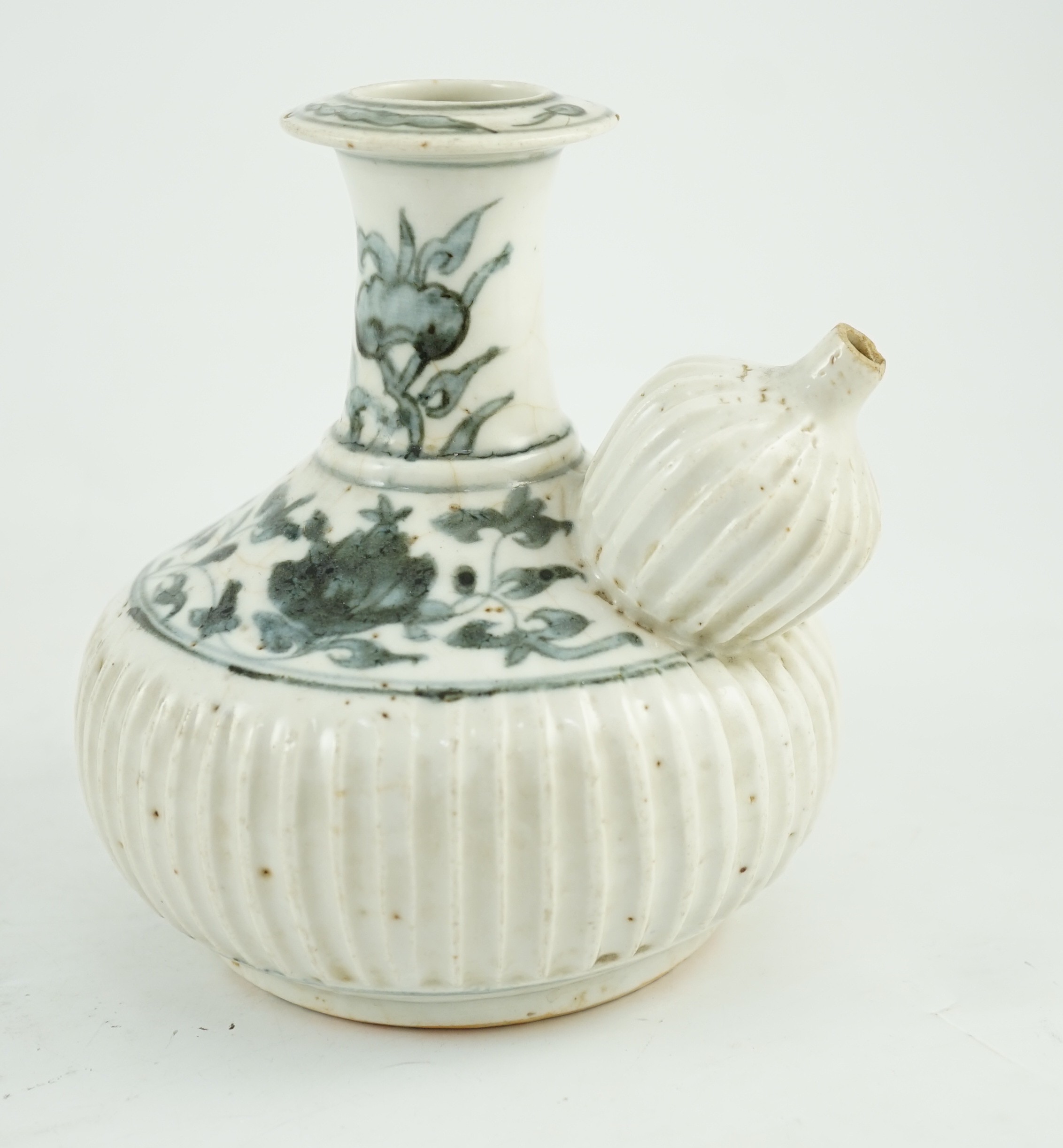 A Chinese late Ming blue and white fluted kendi, Zhangzhou kilns, 16cm high, small chips and glaze cracks